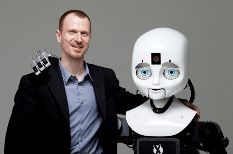 Professor Matthias Scheutz with his team's robot, "Cindy," in the Human Robot Interaction Lab