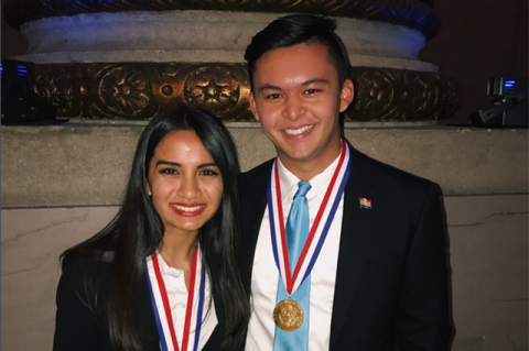 Two Tufts students post with their Presidential Scholar medallions.
