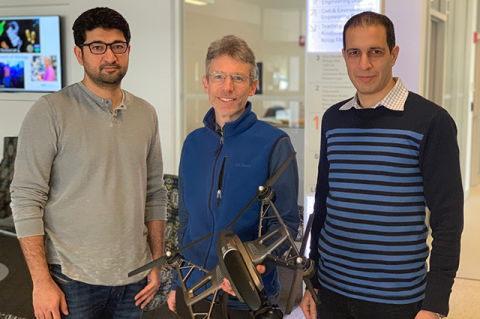 Professors Khan, Rife, and Moaveni standing together, with Professor Rife holding a drone