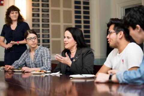 With Professor and Dean of Graduate Education Karen Panetta looking on, Debbie Martínez speaks with Tufts students at a lunch table.