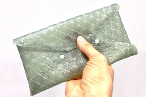 A small clutch purse demonstrates the utility of silk leather in manufacturing products